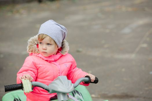 attractive little girl on outdoor playground equipment