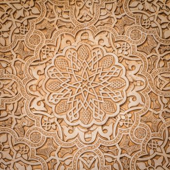 Wall detail of Alhambra UNESCO site in Granada - South of Spain. 600 years old arabic characters.