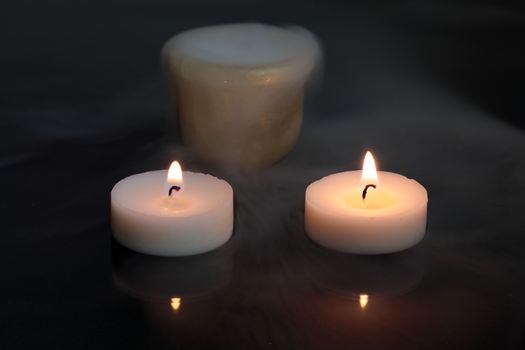 A candles with a pot of dry ice.