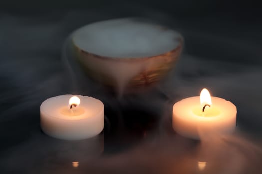 A candles with a pot of dry ice.