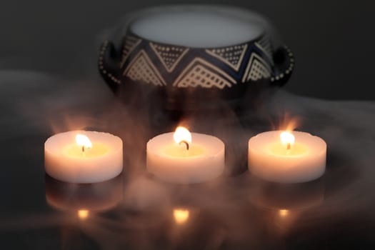 A candles with a pot of dry ice.