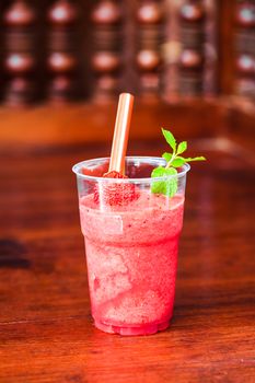 Cold Strawberry Slush in clear plastic glass