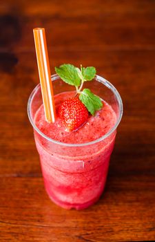 Cold Strawberry Smoothie on wooden table
