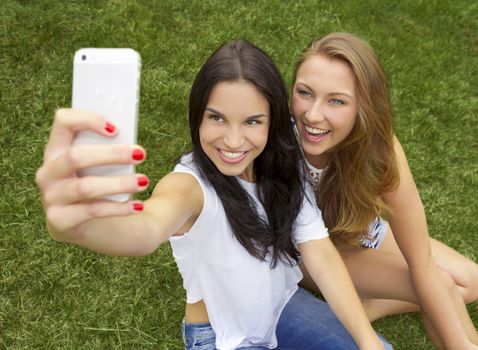 Beautiful and happy teenagers taking selfies