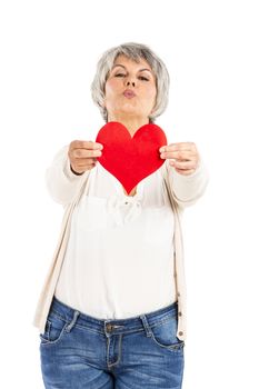 Elderly woman holding a heart shape in her hands, isolated on white background