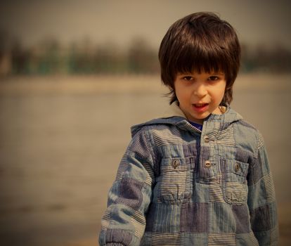 obstinate  little boy in blue jacket, instagram image style