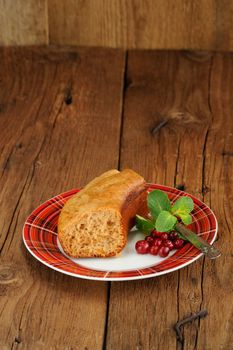 Homemade cake with cranberries and mint with old wood space background