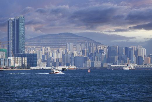 Hong Kong, Hong Kong S.A.R. - JENUARY 29, 2014: Star ferry crossing the Victoria Harbor with a view of Hong Kong Island skyline in the background.