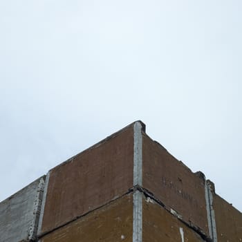 Stacks of large industrial crates against cloudy sky