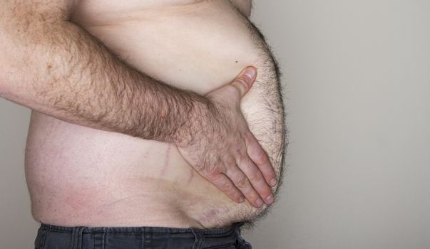 Profile view of a large mans belly with some copy space to the side