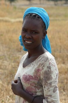 GREAT RIFT VALLEY, ETHIOPIA - NOVEMBER 16, 2014: Young Ethiopian woman on a field on November 23, 2014 in the Great Rift Valley, Ethiopia, Africa