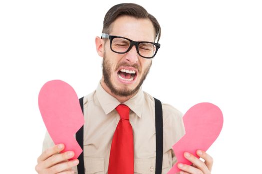 Geeky hipster crying and holding broken heart card on white background