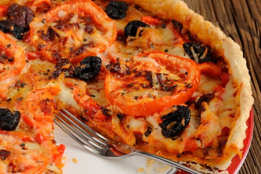 Tomato tart with olives and red pepper closeup macro horizontal