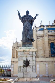 Madrid, Spain - May 6, 2012: Pope John Paul II statue and Cathedral Almudena on a spring day in Madrid, Spain
