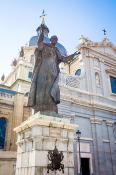 Madrid, Spain - May 6, 2012: Pope John Paul II statue in front of Cathedral Almudena on a spring day in Madrid, Spain
