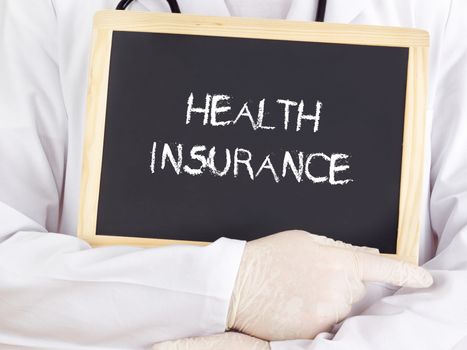 Doctor shows information on blackboard: health insurance