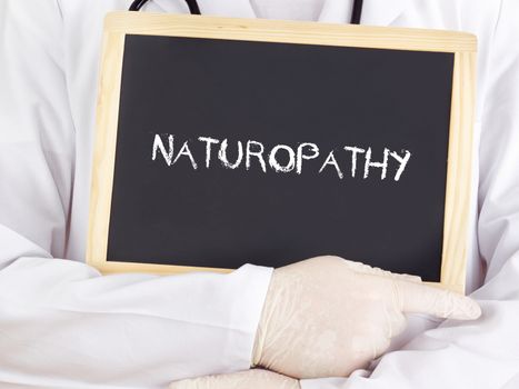 Doctor shows information on blackboard: naturopathy