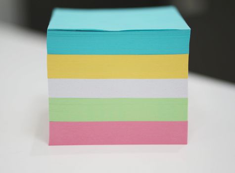 Multicolored note pads put up a set on my desk at the office.                               