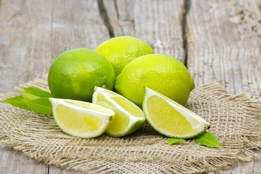 fresh lime fruits on wooden background