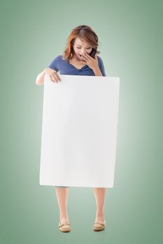 Excited Asian girl hold a blank board, full length portrait isolated.