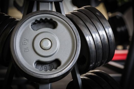 Gym interior with barbell plates holder rack