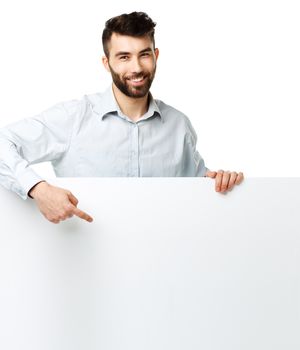 A young bearded man showing blank signboard, isolated over white background