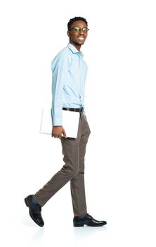 Happy african american college student standing with laptop on white background