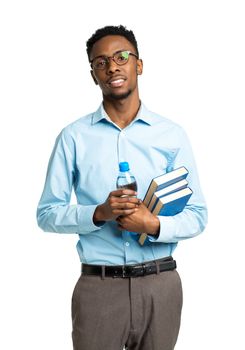 Happy african american college student standing with books and bottle of water in his hands on white background