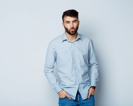 A young bearded man with a serious expression on his face