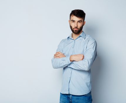 A young bearded man with a serious expression on his face