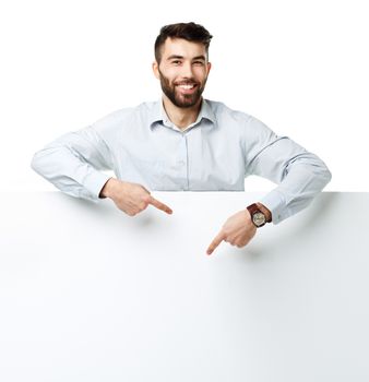 A young bearded man showing blank signboard, isolated over white background