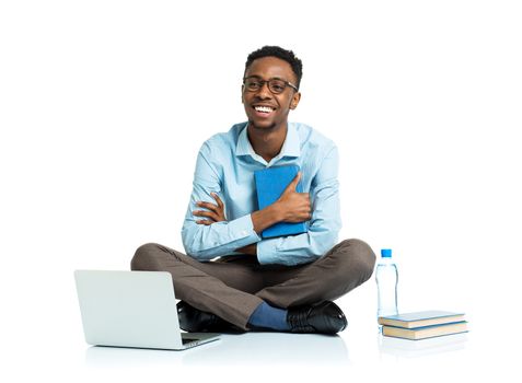 Happy african american college student sitting with laptop on white background