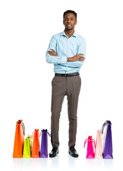 Happy african american man with shopping bags on white background. Christmas and holidays concept