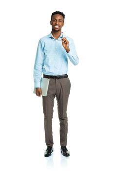 Happy african american college student standing with laptop on white background