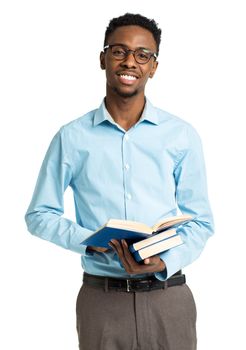 Happy african american college student standing with books in his hands on white background