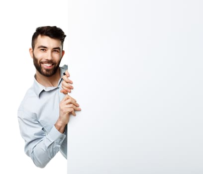 A young bearded man showing blank signboard, isolated over white background