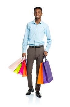 Happy african american man holding shopping bags on white background. Christmas and holidays concept