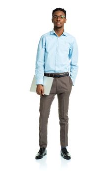 Happy african american college student standing with laptop on white background