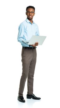 Happy african american college student standing with laptop on white background