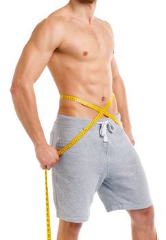 Athletic man with measuring tape on the white background