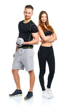 Athletic man and woman with dumbbells on the white background