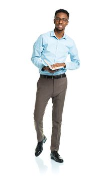 Happy african american college student standing with book on white background