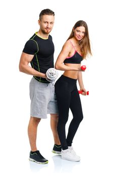 Athletic man and woman with dumbbells on the white background