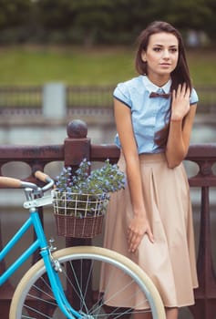 Young beautiful, elegantly dressed woman with bicycle. Beauty, fashion and lifestyle