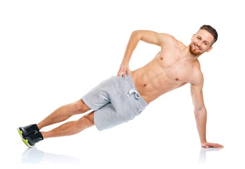 Athletic attractive man doing fitness exercises on the white background