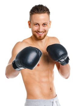 Athletic attractive man wearing boxing gloves on the white background