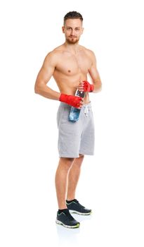 Athletic attractive man wearing boxing bandages with bottle of water on the white background