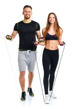 Happy athletic couple - man and woman with with ropes on the white background