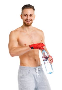 Athletic attractive man wearing boxing bandages with bottle of water on the white background