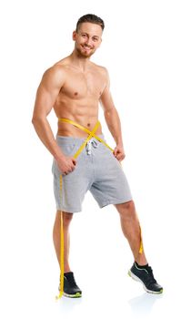 Athletic man with measuring tape on the white background